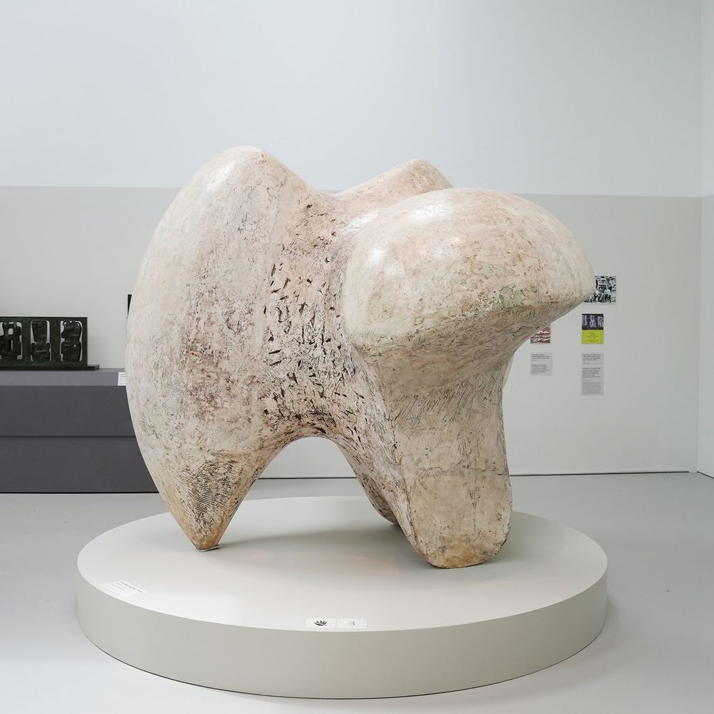 A large, abstract plaster sculpture by Henry Moore, which resembles an oversized vertebra or tooth.