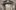 Marble relief sculpture of the Madonna and Child, with angels to either side.